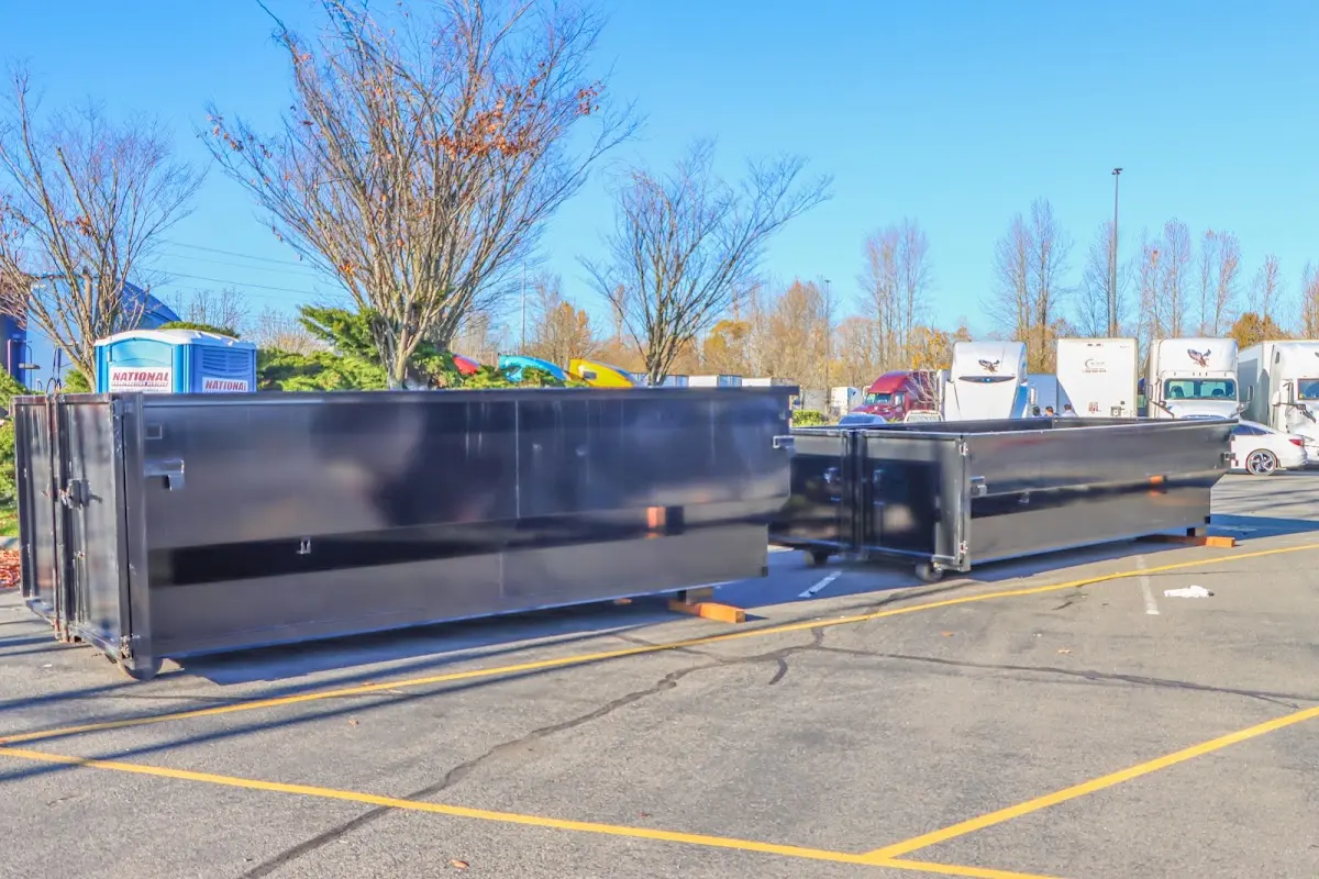 Professional dumpster rental service with roll-off container on residential driveway in Pharr